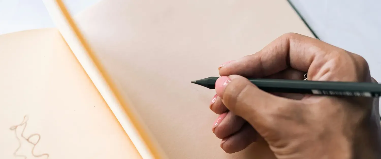 [Photo by Kseniya Budko](https://www.pexels.com/photo/a-person-holding-a-pencil-9025560/)