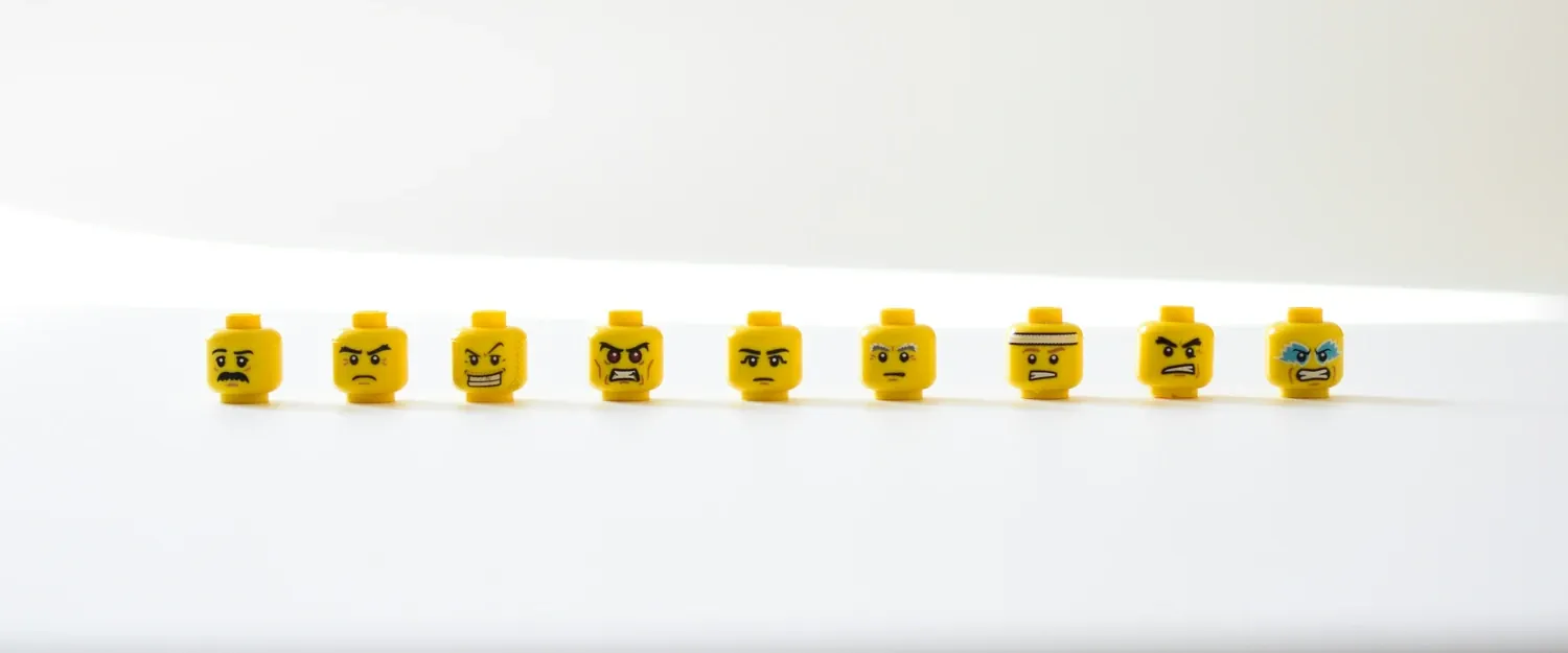 Lego heads showing different angry facial expressions