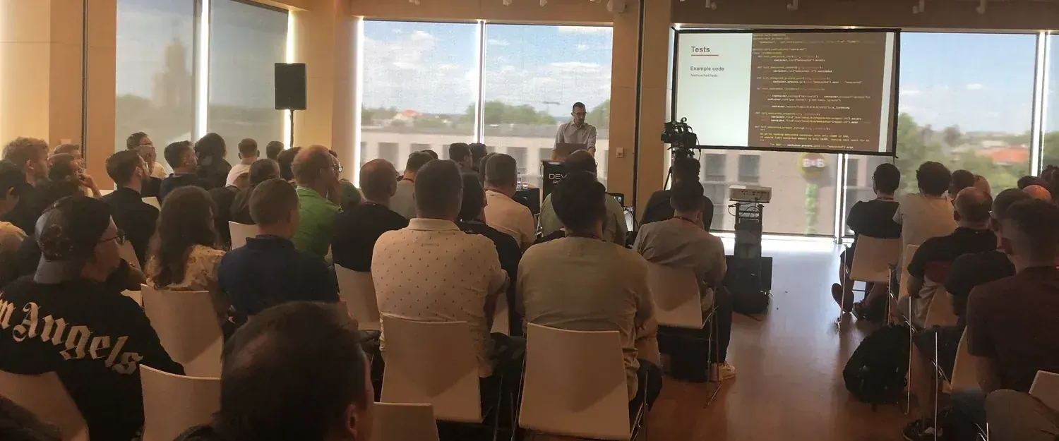 Author speaking at Devoxx 2022 conference with a presentation slide in the background